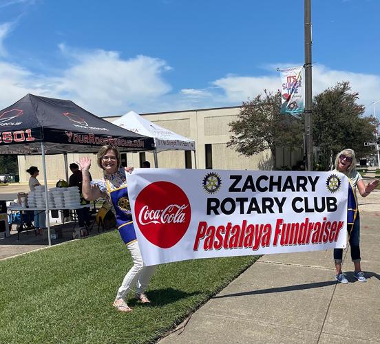 Rotary Pastalaya sign holding.jpg